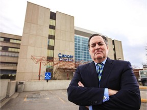 Cancer survivor John Osler is disappointed in the delays the government has had in building the new cancer centre. Here he is seen in front of the current Tom Baker Cancer Centre in Calgary on Thursday, March 26, 2015.