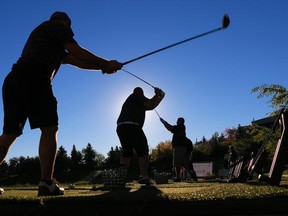 Golfers warm up on the driving range at the  Hamptons Golf Club on Tuesday Sept. 16, 2014.