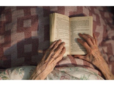 Jeannette Dwyer, 79, reads her book at the Rosedale Hospice in Calgary on Friday, March 20, 2015.  Jeanette has terminal cancer (and has very little time left), but looks back on life with an amazingly positive and grateful attitude.