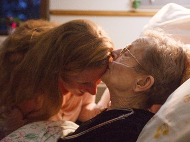 Jeannette Dwyer, 79, kisses her daughter Erin Dolan's forehead at the Rosedale Hospice in Calgary on Friday, March 20, 2015.  Jeanette has terminal cancer (and has very little time left), but looks back on life with an amazingly positive and grateful attitude.