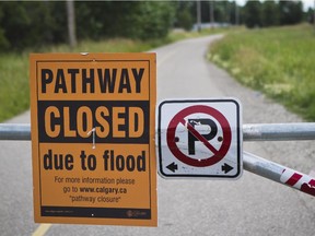 A sign that notifies  the public that the pathway to the Inglewood Bird Sanctuary is closed due to flooding is photographed on  Monday, August 5, 2013.