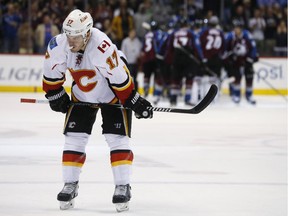 Calgary Flames centre Lance Bouma skates away while members of the Colorado Avalanche gather as time runs out in the third period on Saturday. Despite another Flames' rally attempt, the Avalanche won 3-2.