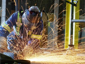 HC Piper structural fitter welder Peter Greer, seen on June 21, 2010, ground down the platform of structure being built for Alberta's oilsands at the Calgary manufacturing facility.