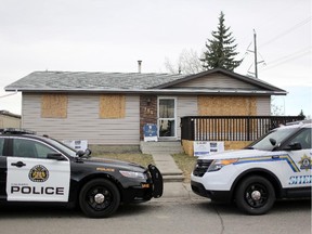 Calgarty Police and Sheriff at the scene of a trashed drug house in Marlborough Park on March 27, 2015.