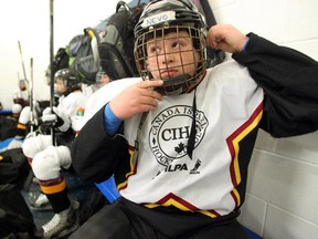 Canada-Israel Hockey School player Nevo Eshel fastened his helmet as he prepared for their game in Calgary on March 10, 2015. The program, which runs in Israel, has the goal to build relationships through hockey in the interest of a more peaceful world. Twenty young male and female players are visiting Canada as part of the program.