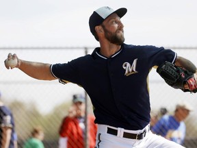 Jim Henderson throws during a Milwaukee Brewers' spring training workout last February in Phoenix.