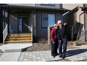 Jack and Karen Grant in front of the Kingsmith show home in The Willows of River Heights Cochrane.