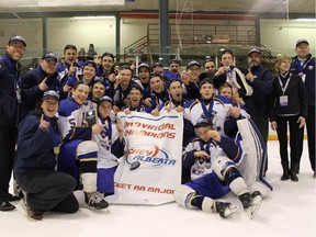 Members of the Calgary Royals celebrate with their provincial banner after capturing the Alberta Major Midget AA hockey crown in Red Deer on Sunday.