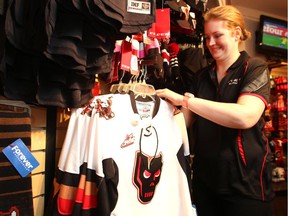 FanAttic sales associate Kelsey Engbloom sorts through Calgary Hitmen jerseys at the store in North Hill Centre on March 26, 2015.