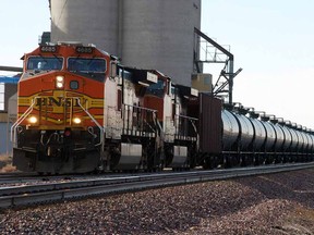 FILE - In this Nov. 6, 2013, file photo, a BNSF Railway train hauls crude oil near Wolf Point, Mont.