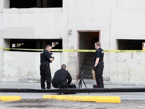 Police investigate after the body of a woman was found in a parkade in the 900 block of 9th Ave. S.W. on March 8, 2015.