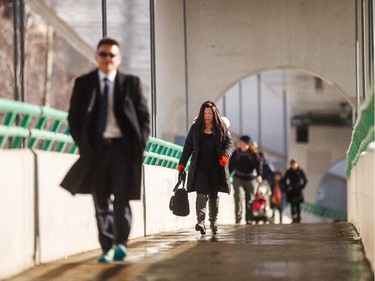 Pedestrians walk across the 10th st. bridge in Calgary on Monday, March 16, 2015. Pedestrian safety is a concern in Calgary.