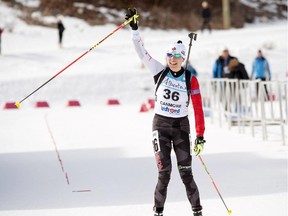 Zina Kocher waves to the crowd as she crosses the line second in Sunday's women's sprint race at the IBU Cup, held at the Canmore Nordic Centre on Sunday. The event continues through next weekend.