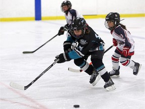 Kids compete during the finals of the ESSO minor hockey week in Calgary, on January 17, 2015.