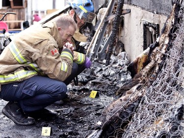 Members of the Calgary Fire Department on the scene of a house fire on 50 St NE in the community of Rundle in Calgary on March 27, 2015.