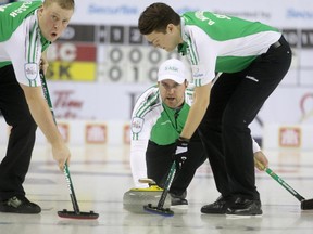 Team Saskatchewan skip Steve Laycock, middle, Colton Flasch, left and Dallan Muyres, right, during their game against Team British Columbia at the Tim Hortons Brier at the Scotiabank Saddledome in Calgary on March 6, 2015.