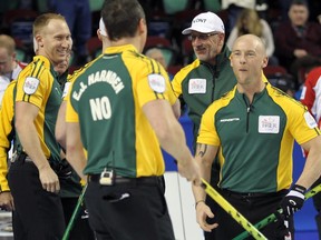 Brad Jacobs, left, with teammates E.J. Harnden, and Ryan Fry of Northern Ontario celebrate winning the 1-2 Page playoff matchup on Friday March 6, 2015 at the Tim Hortons Brier.