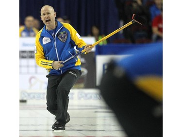 Alberta skip Kevin Koe screamed to his sweepers as they carried his shot down the ice against Saskatchewan during the afternoon draw at the Tim Hortons Brier at the Scotiabank Saddledome in Calgary on March 5, 2015.
