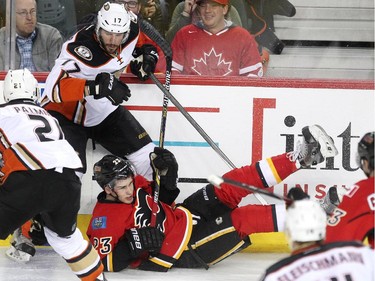 Calgary Flames centre Sean Monahan crashed to the ice after getting tangled up with Anaheim Ducks centre Ryan Kesler during first period NHL action at the Scotiabank Saddledome on March 11, 2015.