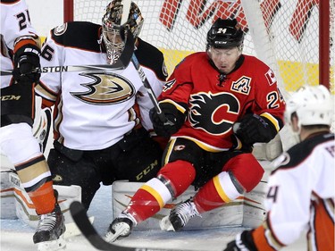 Calgary Flames centre Jiri Hudler fell back onto Anaheim Ducks goalie John Gibson during first period NHL action at the Scotiabank Saddledome on March 11, 2015.