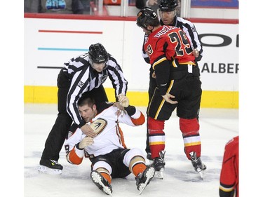 Calgary Flames defenceman Deryk Engelland looked down after decking Anaheim Ducks left winger Patrick Maroon in a fight near centre ice during first period NHL action at the Scotiabank Saddledome on March 11, 2015.