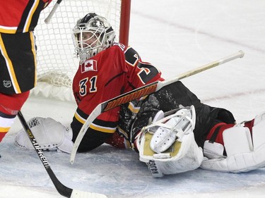 Calgary Flames goalie Karri Ramo peered back over his shoulder as his stick came to rest on his back after stopping a shot by the Anaheim Ducks during first period NHL action at the Scotiabank Saddledome on March 11, 2015.