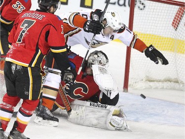 Calgary Flames goalie Karri Ramo looked over his shoulder as a shot sailed into the net as Anaheim Ducks right winger Corey Perry crashed into him during second period NHL action at the Scotiabank Saddledome on March 11, 2015.