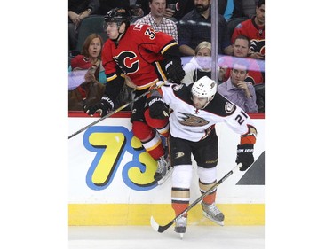 Calgary Flames defenceman Raphael Diaz flew halfway up the boards as he was driven into them by Anaheim Ducks right winger Kyle Palmieri during second period NHL action at the Scotiabank Saddledome on March 11, 2015.