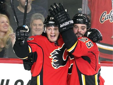 Calgary Flames centre Matt Stajan, left, and left winger Brandon Bollig celebrated after Stajan scored the Flames third goal of teh game against the Anaheim Ducks during second period NHL action at the Scotiabank Saddledome on March 11, 2015.