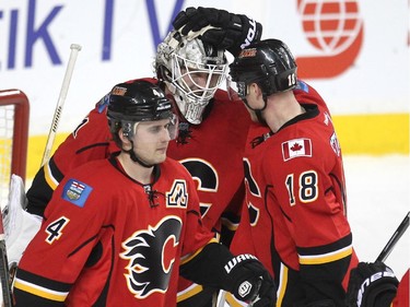 Calgary Flames goalie Karri Ramo got congratulated by centre Matt Stajan after posting the win against the Anaheim Ducks during third period NHL action at the Scotiabank Saddledome on March 11, 2015. The Flames won the game 6-3.