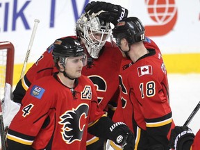 Calgary Flames goalie Karri Ramo got congratulated by centre Matt Stajan after posting the win against the Anaheim Ducks at the Scotiabank Saddledome on March 11, 2015. The Flames won the game 6-3.