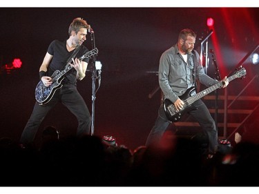 Nickelback lead singer Chad Kroeger, left, played alongside other band members as they played to the packed crowd during their tour stop in Calgary at the Scotiabank Saddledome on  March 12, 2015.