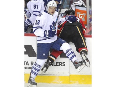 Calgary Flames centre Sean Monahan was driven into the Toronto Maple Leafs bench by Leafs right winger Richard Panik during first period NHL action at the Scotiabank Saddledome on March 13, 2015.