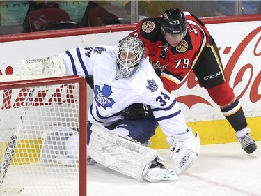 Calgary Flames left winger Michael Ferland got caught up with Toronto Maple Leafs goalie James Reimer during first period NHL action at the Scotiabank Saddledome on March 13, 2015.