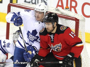 Calgary Flames right winger David Jones battled Toronto Maple Leafs defenceman Dion Phaneuf infront of the Leafs net during second period NHL action at the Scotiabank Saddledome on March 13, 2015.