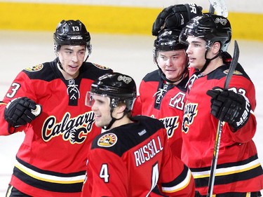 Members of the Calgary Flames, from right, left winger Johnny Gaudreau, defenceman Kris Russell, centre Jiri Hudler and centre Sean Monahan celebrated after Hudler scored against the Flames sixth goal of the game against the Toronto Maple Leafs during second period NHL action at the Scotiabank Saddledome on March 13, 2015.
