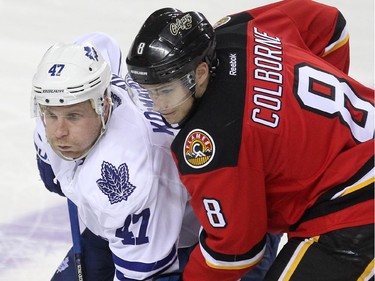 Calgary Flames centre Joe Colborne and Toronto Maple Leafs centre Leo Komarov jostled for positon during a faceoff during third period NHL action at the Scotiabank Saddledome on March 13, 2015. The Flames defeated the Leafs 6-3.