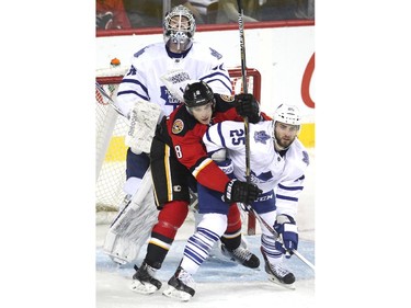 Calgary Flames centre Joe Colborne and Toronto Maple Leafs defenceman TJ Brennan jostled for positon infront of Leafs goalie James Reimer during third period NHL action at the Scotiabank Saddledome on March 13, 2015. The Flames defeated the Leafs 6-3.
