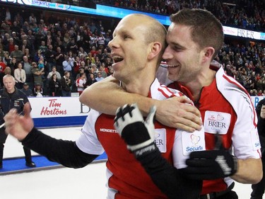 Team Canada's skip Pat Simmons and third John Morris celebrate winning the gold medal final of the 2015 Tim Horton's Brier on Sunday March 8, 2015. Team Canada downed Brad Jacob's Northern Ontario team 6-5 in an extra end.