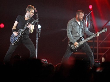 Nickelback lead singer Chad Kroeger, left, played alongside his brother Mike Kroeger and the other band members in front of the packed crowd during their tour stop in Calgary at the Scotiabank Saddledome on  March 12, 2015.