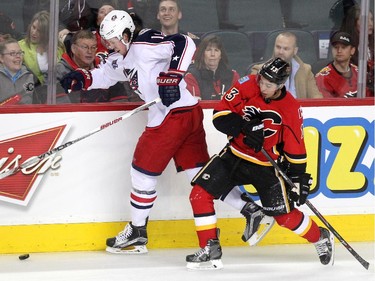 Calgary Flames left winger Johnny Gaudreau tried to run Columbus Blue Jackets centre Ryan Johansen into the boards during first period NHL action at the Scotiabank Saddledome on March 20, 2015.