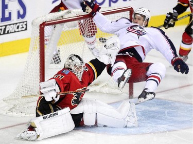 Calgary Flames goalie Karri Ramo kept his composure as Columbus Blue Jackets centre Boone Jenner crashed into the net during first period NHL action at the Scotiabank Saddledome on March 21, 2015.