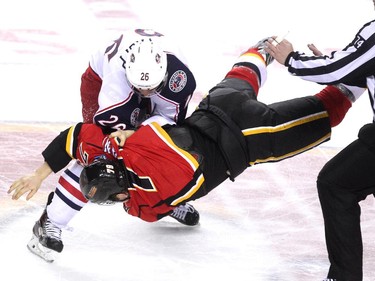 Calgary Flames left winger Michael Ferland flew to the ice during a fight against Columbus Blue Jackets right winger Corey Tropp during second period NHL action at the Scotiabank Saddledome on March 21, 2015.