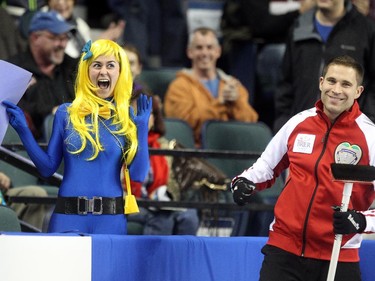 Lac La Biche's Danika Richard, left, reacted after getting a kiss from Team Canada Skip John Morris in between the 6th and 7th ends during the Tim Hortons Brier at the Scotiabank Saddledome on March 1, 2015.