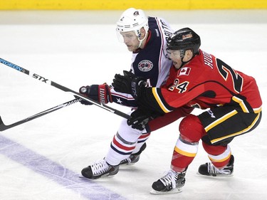 Calgary Flames centre Jiri Hudler and Columbus Blue Jackets defenceman Kevin Connauton got tied up during third period NHL action at the Scotiabank Saddledome on March 21, 2015. The Flames lost 3-2 in overtime.