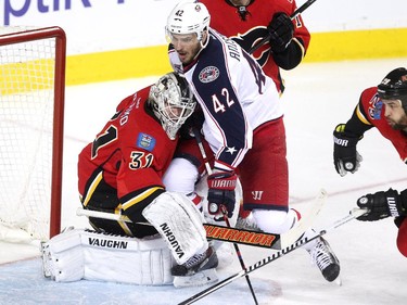 Calgary Flames goalie Karri Ramo got tied up with Columbus Blue Jackets centre Artem Anisimov during third period NHL action at the Scotiabank Saddledome on March 21, 2015. The Flames lost 3-2 in overtime.