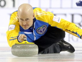 Team Alberta skip Kevin Koe throws a rock against B.C.'s Jim Cotter on Saturday night. The Calgarian was so sick during the draw that he puked between ends.