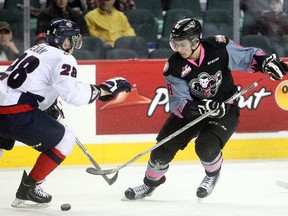 Hitmen power forward Jake Virtanen, seen going against Lethbridge's Brady Reagan in a game earlier this month, hasn't seen much daylight against the Kootenay Ice in the opening round of the WHL playoffs so far. The Vancouver Canucks prospect has yet to hit the scoresheet.