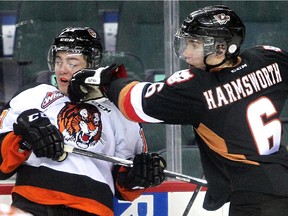 Calgary Hitmen defenceman Colby Harmsworth gets in the face of Medicine Hat's Blake Penner during a game last September. Harmsworth delivered another punch to Medicine Hat after his OT winner gave Calgary two points against Kamloops, keeping them two points up on the Tigers for top spot in the WHL's Central Division.