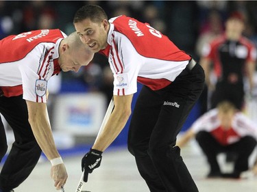 Team Canada lead Nolan Thiessen, left, and third John Morris carried a shot by second Carter Rycroft, background, down the ice during the afternoon draw against Ontario during the Tim Hortons Brier at the Scotiabank Saddledome on March 4, 2015.